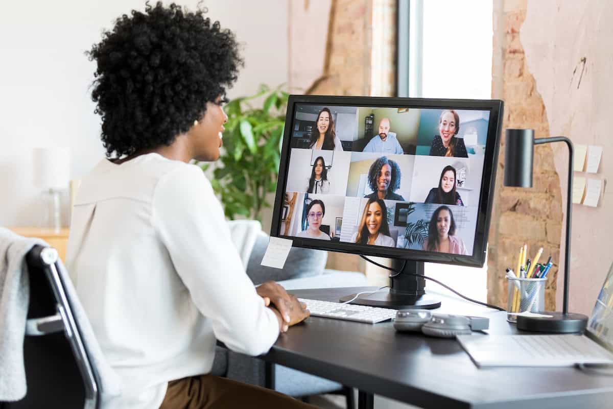 Businesswoman participates in video conference on Gen AI Training.