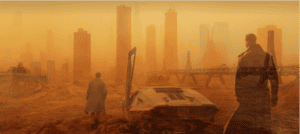 A composite image blending two similar scenes in a warm, orange, dystopian cityscape. In the foreground on the left, a man in a long coat walks toward a futuristic skyline, passing a parked sci-fi vehicle with its gull-wing door open. Overlaid on the right is the semi-transparent figure of another man in a long coat, standing and gazing at the city from a rocky, orange terrain. Tall futuristic skyscrapers rise in the hazy background.